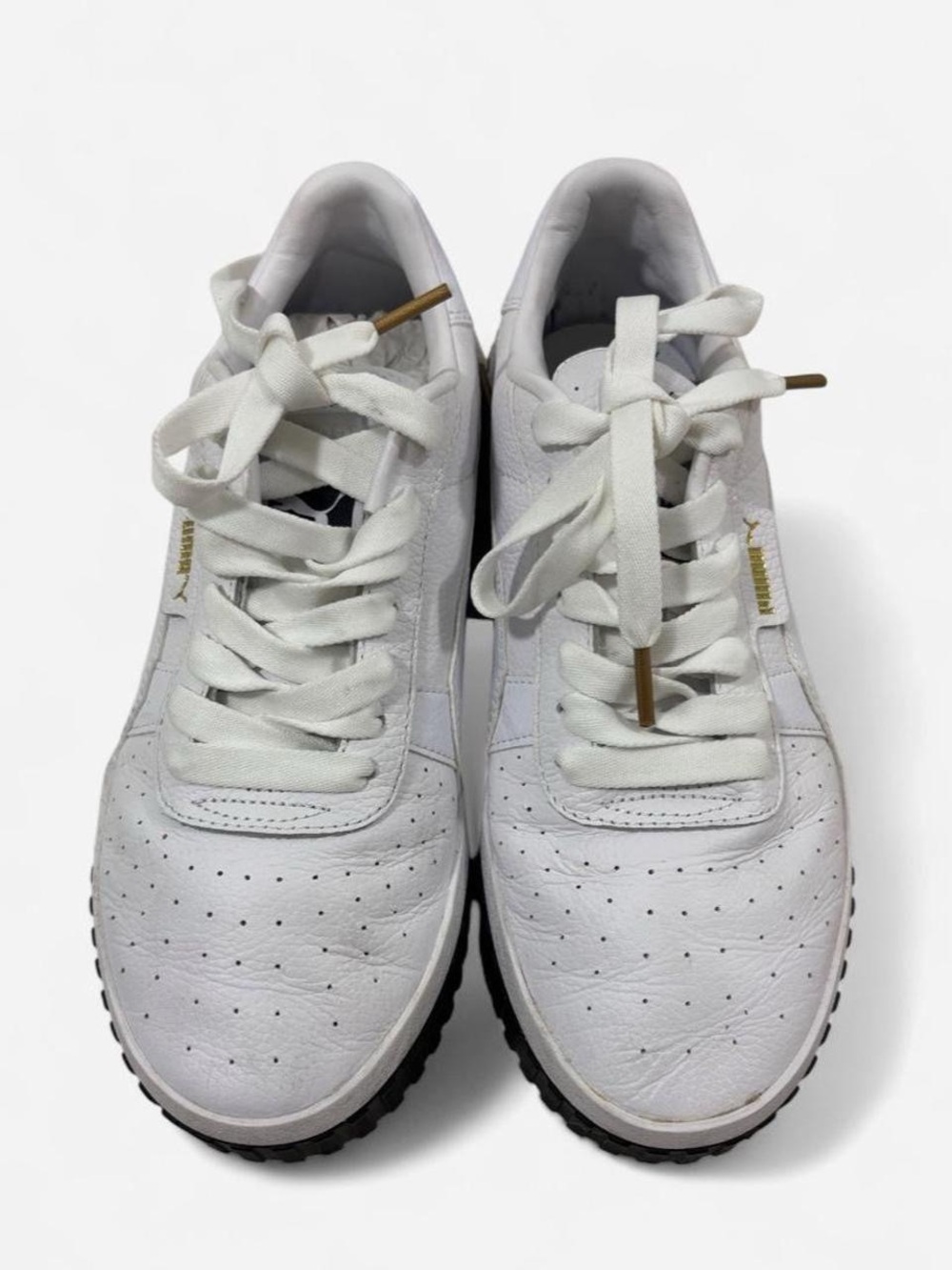 Puma white leather sneakers with gold accents,